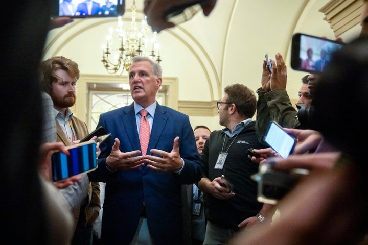 Speaker of the House Kevin McCarthy, R-Calif., is surrounded by reporters looking for updates on plans to fund the government and avert a shutdown, at the Capitol in Washington, Friday, Sept. 22, 2023. (AP Photo/Mark Schiefelbein)