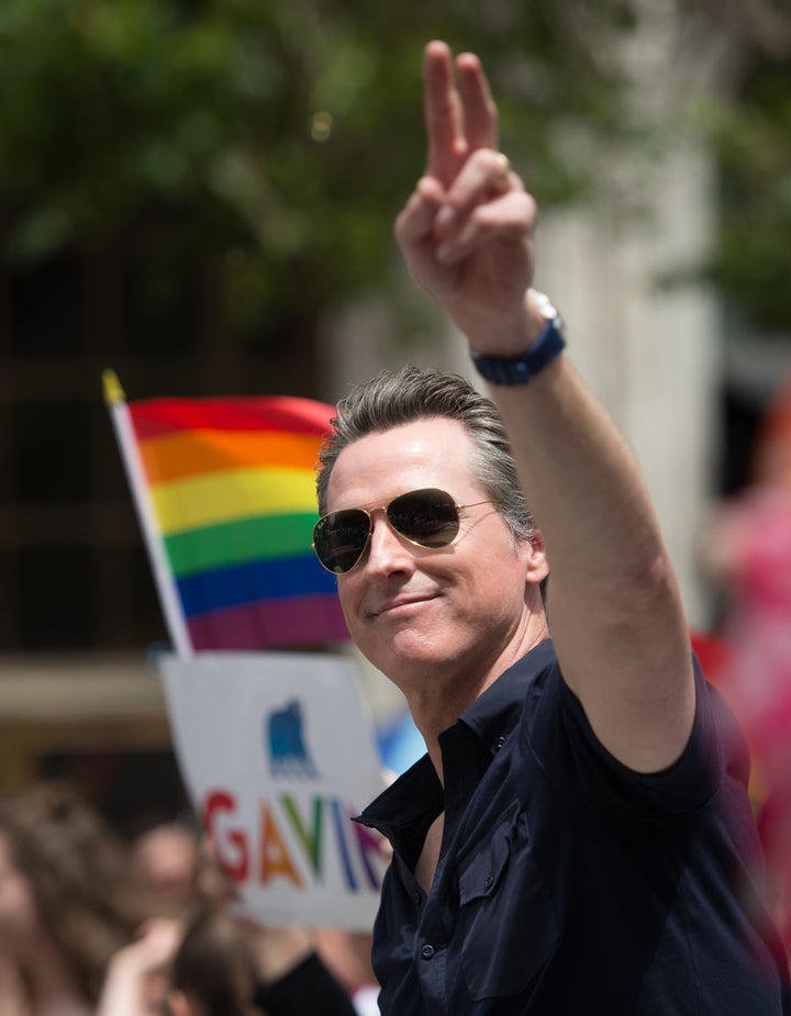 Gavin Newsom waves to a crowd during the San Francisco Pride parade on June, 25, 2017.