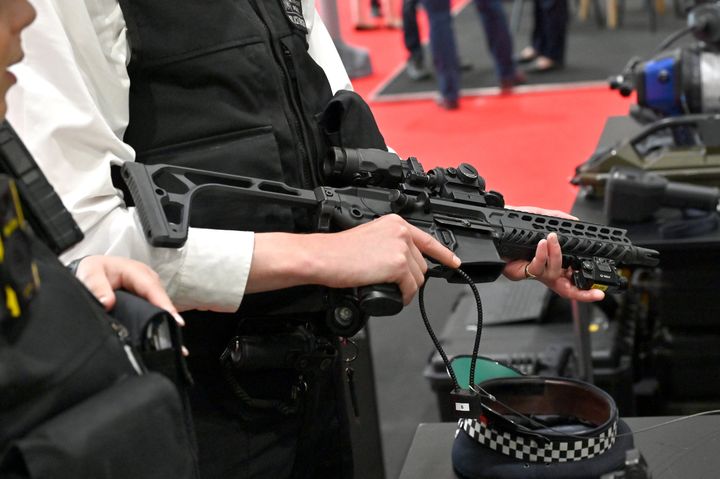 A Metropolitan Police officer holds a Sig Sauer semi-automatic rifle at the British Transport Police stand during the Counter Terror And Forensics Europe Expo 2023 at ExCel on May 17, 2023 in London, England.