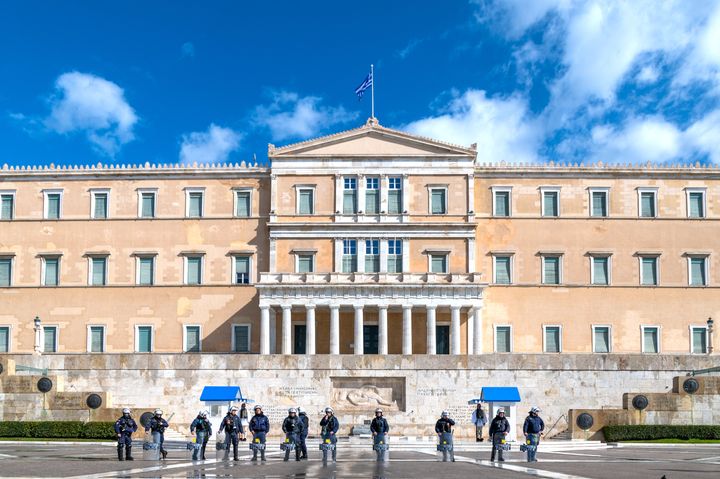 This is a photo of riot police is full gear protecting the Greek parliament in Athens, Greece