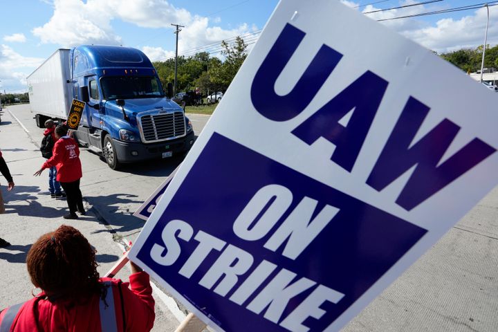 United Auto Workers members walk the picket line Sept. 18, blocking a truck from entering a Ford assembly plant in Wayne, Michigan. 