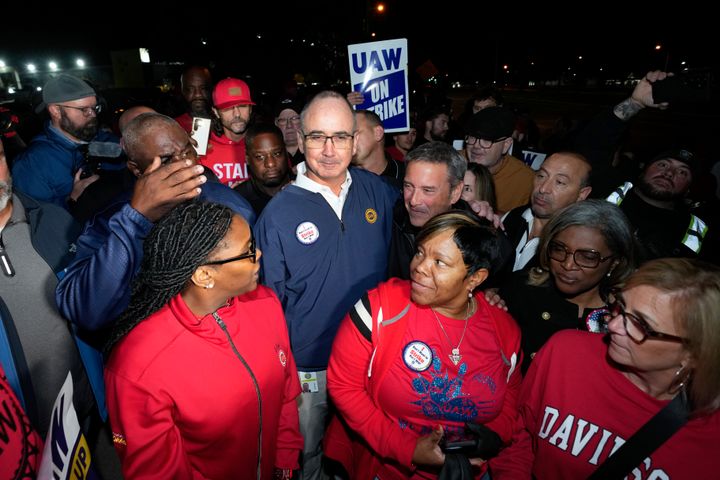 United Auto Workers President Shawn Fain (center) invited President Biden to the picket line amid the union's historic strike.