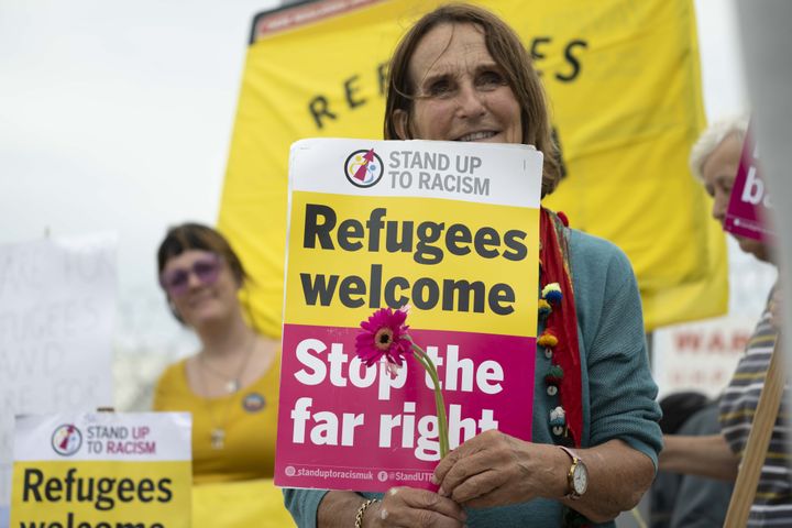 A group of supportive demonstrators welcome asylum-seekers from Dorset, in August.