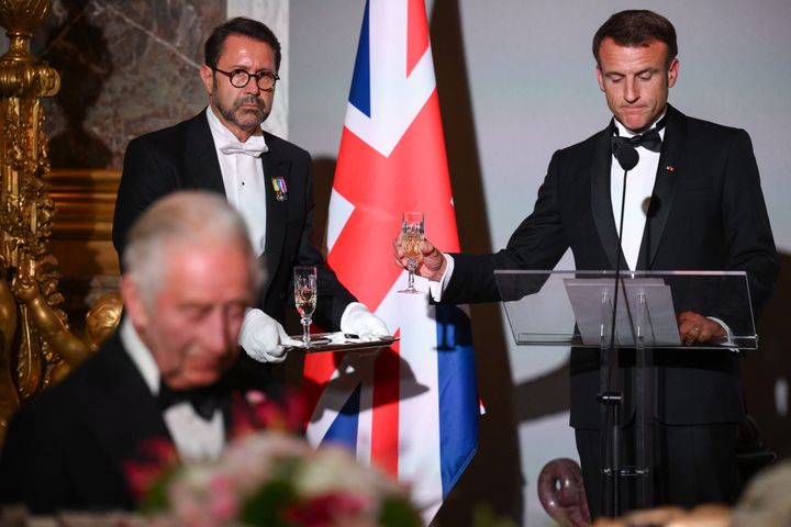 晩餐会でのチャールズ英国王とマクロン仏大統領。写り込む給仕係の男性が番組ホストにそっくり…？