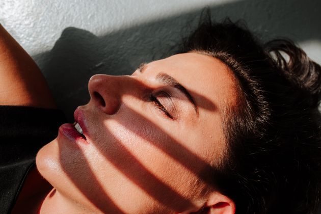 Hand shadow on woman's face. Mental health idea.