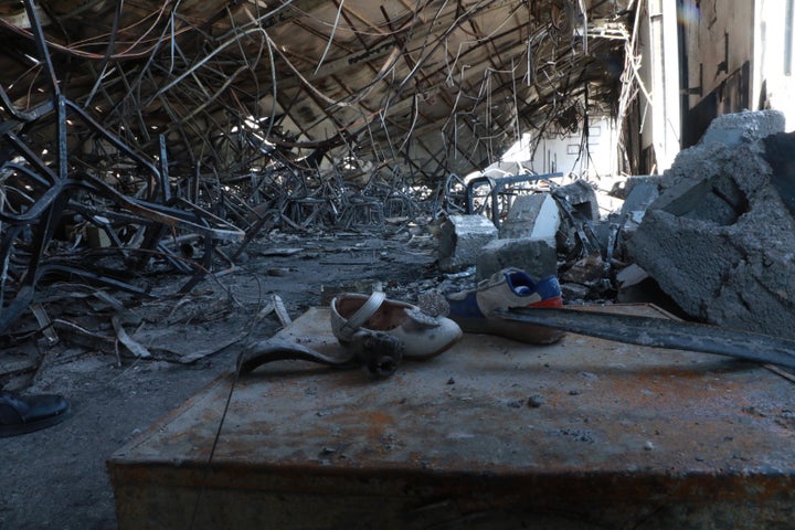 Damaged children's shoes are pictured Wednesday at the scene of the former wedding hall.