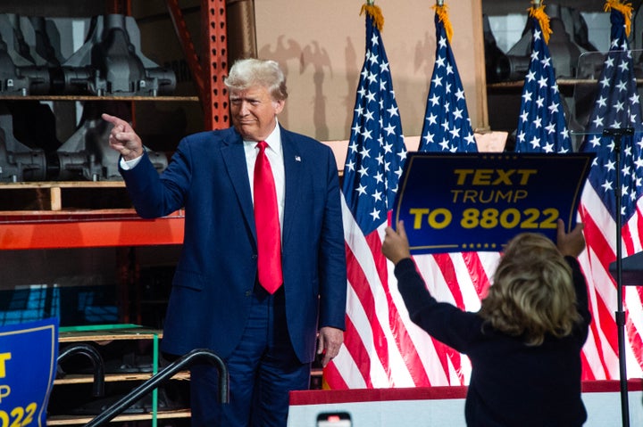 Donald Trump was in Michigan to court blue-collar workers but there were questions about the rally attendees.