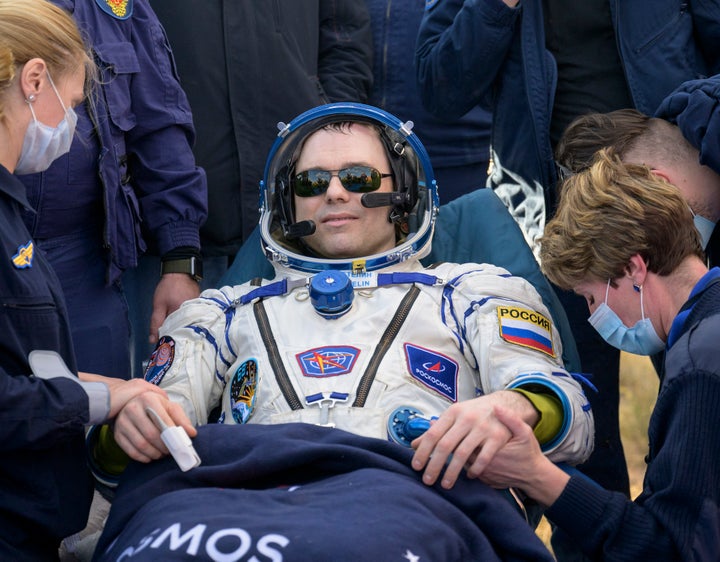 Cosmonaut Dmitri Petelin is seen outside the Soyuz MS-23 spacecraft 