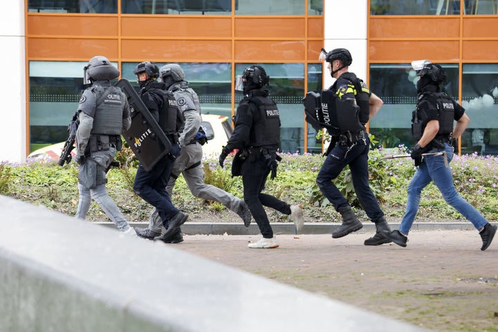 Netherlands' police officers move towards The Erasmus University Medical Center in Rotterdam on September 28, 2023, which was cordoned off after two reported shooting incidents.
