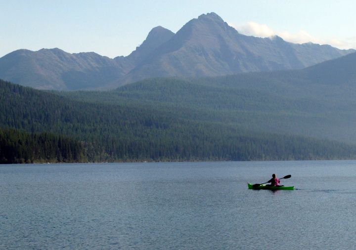 FILE - In this Sept. 6, 2013, file photo, Ingrid Forsmark kayaks on Kintla Lake in Glacier National Park, Montana. (AP Photo/Matt Volz, File)