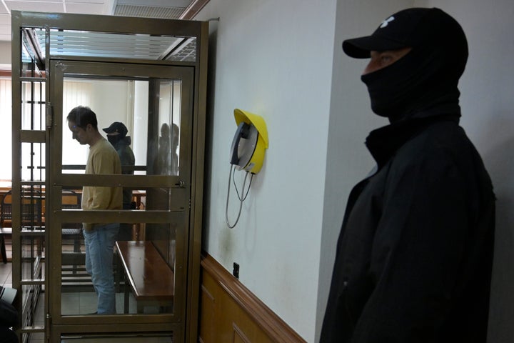 Wall Street Journal reporter Evan Gershkovich stands in a glass cage in a courtroom at the Moscow City Court, in Moscow on Sept. 19, 2023.