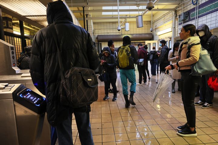 People stand around at the Church Avenue subway station as subway service is stopped amid heavy rain on September 29, 2023 in the Flatbush neighborhood of Brooklyn borough New York City. 