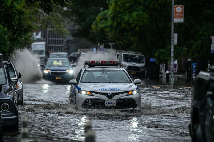 TOPSHOT - Vehicles make their way through floodwater in Brooklyn, New York on September 29, 2023. (Photo by Ed JONES / AFP) (Photo by ED JONES/AFP via Getty Images)