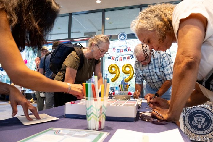 People write birthday cards for former President Jimmy Carter during a celebration for his 99th birthday held at The Carter Center in Atlanta on Saturday. (AP Photo/Ben Gray)