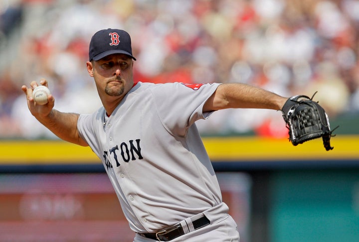 FILE - Boston Red Sox starter Tim Wakefield works in the second inning of a baseball game against the Atlanta Braves in Atlanta, June 27, 2009. Wakefield, the knuckleballing workhorse of the Red Sox pitching staff who bounced back after giving up a season-ending home run to the Yankees in the 2003 playoffs to help Boston win its curse-busting World Series title the following year, has died. He was 57. The Red Sox announced his death in a statement Sunday, Oct. 1 2023, (AP Photo/John Bazemore file)