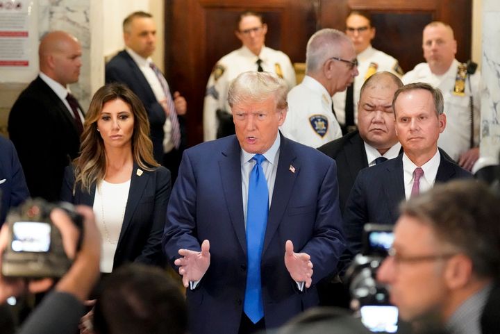Former President Donald Trump, center, arrives at New York Supreme Court, Monday, Oct. 2, 2023, in New York. Trump is making a rare, voluntary trip to court in New York for the start of a civil trial in a lawsuit that already has resulted in a judge ruling that he committed fraud in his business dealings. (AP Photo/Seth Wenig)
