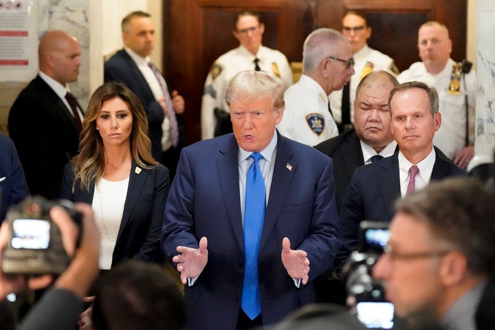 Former President Donald Trump, center, arrives at New York Supreme Court, Monday, Oct. 2, 2023, in New York. Trump is making a rare, voluntary trip to court in New York for the start of a civil trial in a lawsuit that already has resulted in a judge ruling that he committed fraud in his business dealings. (AP Photo/Seth Wenig)