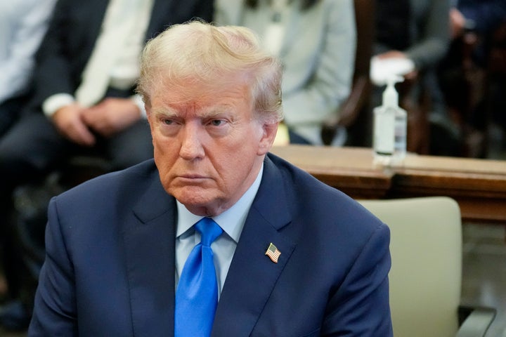 Former President Donald Trump, right, sits in the courtroom at New York Supreme Court, on Oct. 2, 2023, in New York. 