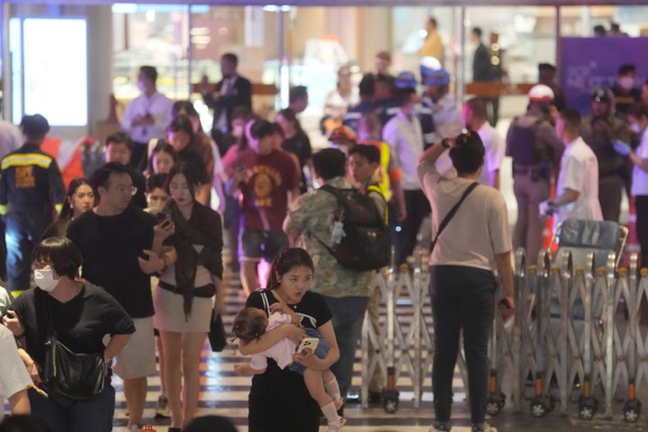 Tourists evacuate from a shopping mall in Bangkok, Thailand, on Oct. 3, 2023. Hundreds of shoppers fled a major shopping mall in the center of the Thai capital Bangkok on Tuesday afternoon after what sounded like gunshots were heard inside.