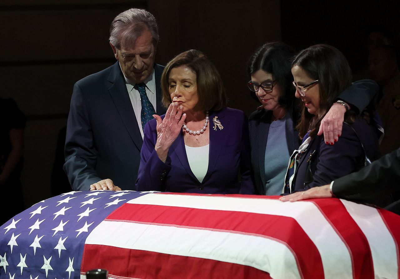 Rep. Nancy Pelosi and her husband, Paul Pelosi, stand over the casket of Sen. Dianne Feinstein as she lies in state at San Francisco City Hall on Oct. 4, 2023.