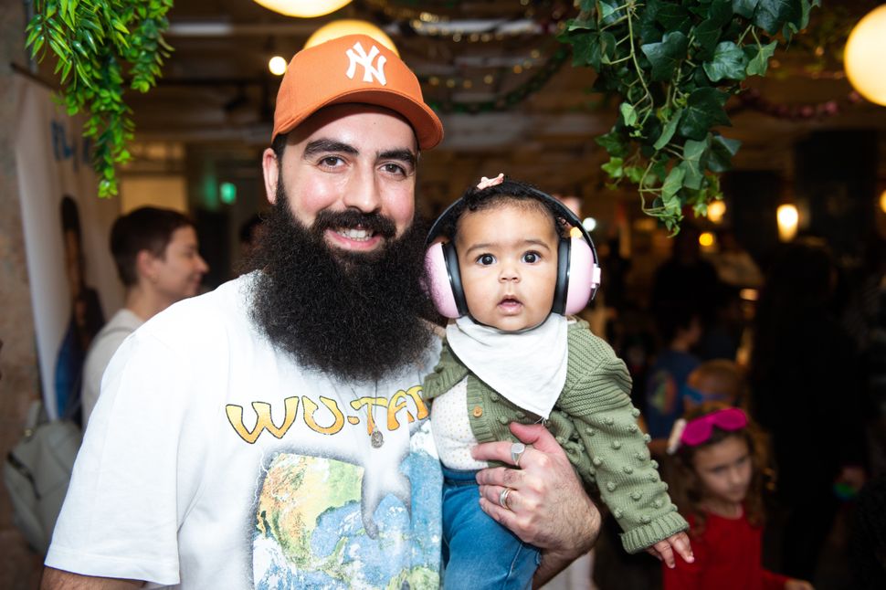 A dad and his baby attend Fly Kid Family Rave.