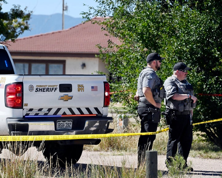 Fremont County deputies guard the road leading to the Return to Nature Funeral Home in Penrose, Colo. Thursday, Oct. 5, 2023.