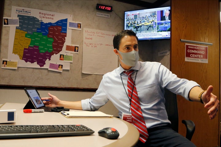 Ohio Secretary of State Frank LaRose talks with staff members at Ohio's election command center in Columbus. LaRose touted the state's smooth 2020 election even as many fellow Republicans expressed unfounded doubts about the presidential result.