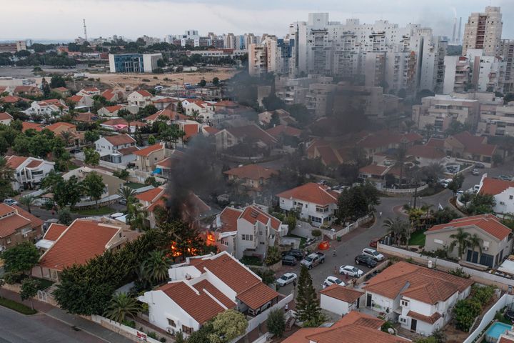 Smoke rises after a rocket fired from the Gaza Strip hit a house in Ashkelon, southern Israel on Saturday. The rockets were fired as Hamas announced a new operation against Israel. (AP Photo/Tsafrir Abayov)