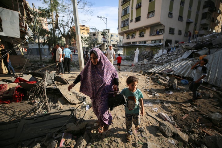 People assess the destruction cause by Israeli air strikes in Gaza City on October 7, 2023. Palestinian militants have begun a ''war'' against Israel which they infiltrated by air, sea and land from the blockaded Gaza Strip, Israeli officials said, a major escalation in the Israeli-Palestinian conflict. (Photo by Majdi Fathi/NurPhoto via Getty Images)