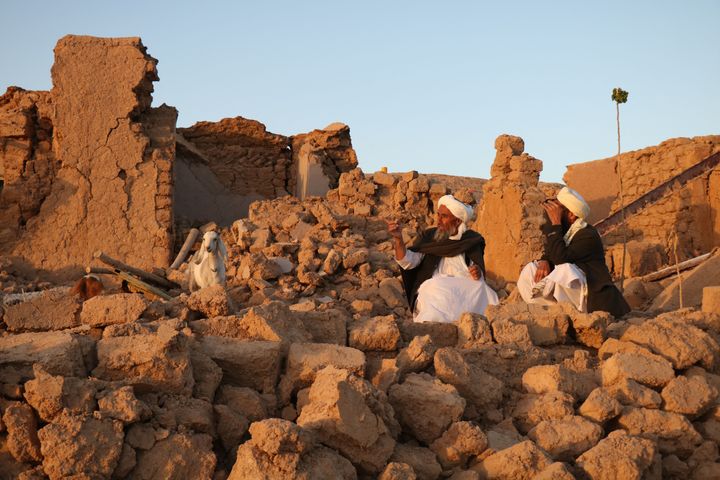 Afghan residents sit at a damaged house after earthquake in Sarbuland village of Zendeh Jan, district of Herat province, on October 7,2023 (Photo by Mohsen KARIMI / AFP) (Photo by MOHSEN KARIMI/AFP via Getty Images)