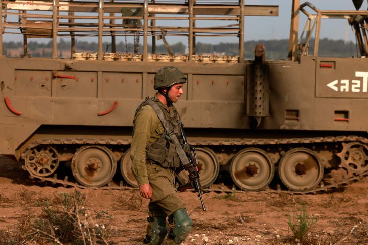 An Israeli soldier takes position at an undisclosed location on the border with the Gaza Strip on October 8, 2023. Israel's prime minister of October 8 warned of a "long and difficult" war, as fighting with Hamas left hundreds killed on both sides after a surprise attack on Israel by the Palestinian militant group. (Photo by Menahem KAHANA / AFP) (Photo by MENAHEM KAHANA/AFP via Getty Images)