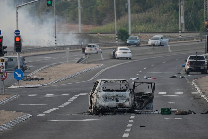 A car destroyed in an attack by Palestinian militants is seen in Sderot, Israel, on Saturday, Oct. 7, 2023. Palestinian militants in the Gaza Strip infiltrated Saturday into southern Israel and fired thousands of rockets into the country while Israel began striking targets in Gaza in response. (AP Photo/Ohad Zwigenberg)