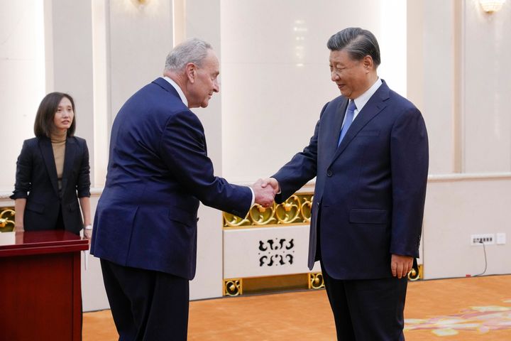 Visiting U.S. Senate Majority Leader Chuck Schumer, D-N.Y., left, is greeted by Chinese President Xi Jinping before their bilateral meeting at the Great Hall of the People in Beijing, on Oct. 9, 2023. 