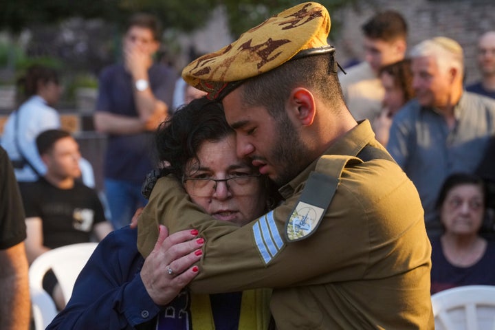 Friends and relatives of Ilai Bar Sade mourn during his funeral at the military cemetery in Tel Aviv on Monday, after he was killed when Hamas militants stormed Israeli towns near the Gaza Strip.