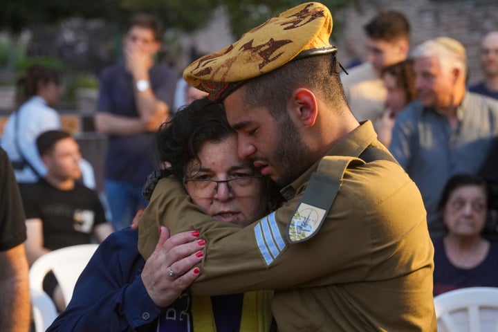 Friends and relatives of Ilai Bar Sade mourn during his funeral at the military cemetery in Tel Aviv, Israel, Monday, Oct. 9, 2023. Bar Sade was killed after Hamas militants stormed from the blockaded Gaza Strip into nearby Israeli towns. Israel's vaunted military and intelligence apparatus was caught completely off guard, bringing heavy battles to its streets for the first time in decades. (AP Photo/Erik Marmor)