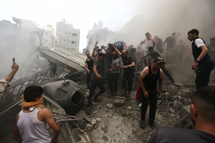 Palestinians remove a dead body from the rubble of a building after an Israeli airstrike Jebaliya refugee camp in the Gaza Strip on Monday.