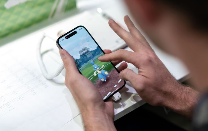 A competitor plays the Pokémon Go game during the 2023 Pokémon World Championships on Aug. 11 in Japan. The app, which launched in 2016, allows users to move through the physical world to discover and catch different types of fictional creatures.