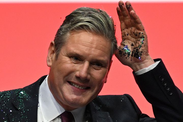 Keir Starmer reacts after a protester threw glitter on him at the start of his keynote address in Liverpool.