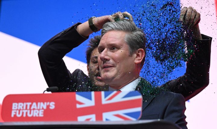 A protester throws glitter on Keir Starmer at the start of his keynote address to delegates on the third day of the annual Labour Party conference in Liverpool.