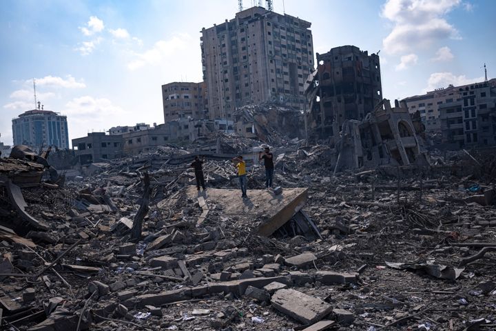 Palestinians inspect the rubble of buildings hit by an Israeli airstrike, in Gaza City, Tuesday, Oct. 10, 2023. The militant Hamas rulers of the Gaza Strip carried out an unprecedented attack on Israel Saturday, killing over 900 people and taking captives. Israel launched heavy retaliatory airstrikes on the enclave, killing hundreds of Palestinians. (AP Photo/Fatima Shbair)