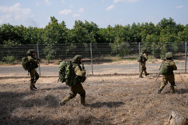 CORRECTS DAY TO SATURDAY - Israeli soldiers deploy in kibbutz Kfar Azza on Tuesday, Oct. 10, 2023. Hamas militants overran Kfar Azza on Saturday, where many Israelis were killed and taken captive. (AP Photo/Ohad Zwigenberg)