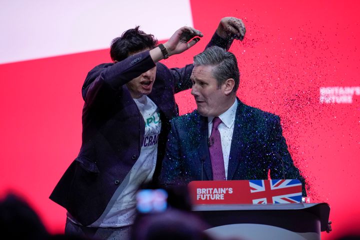 A protestor storms the stage and throws glitter over Keir Starmer during his speech on the third day of the Labour Party conference in Liverpool.
