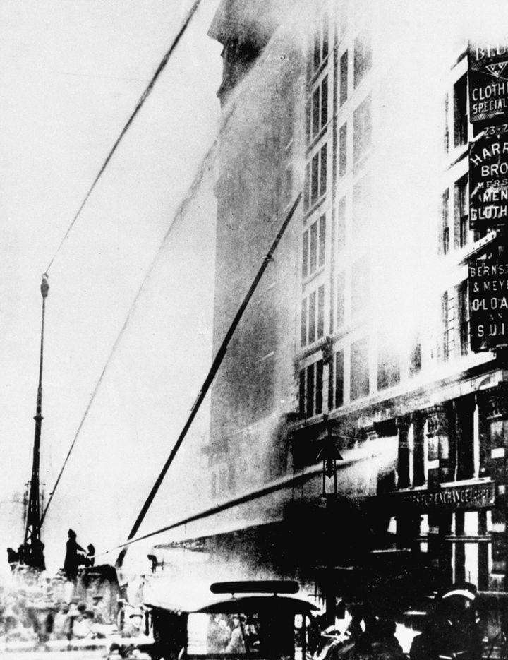 This photo, taken on March 25, 1911, shows firefighters working to put out the fire at the Triangle Shirtwaist Company in New York's Greenwich Village neighborhood. 