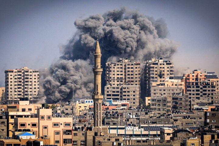 Smoke plumes billow during Israeli air strikes in Gaza City on October 12, 2023.