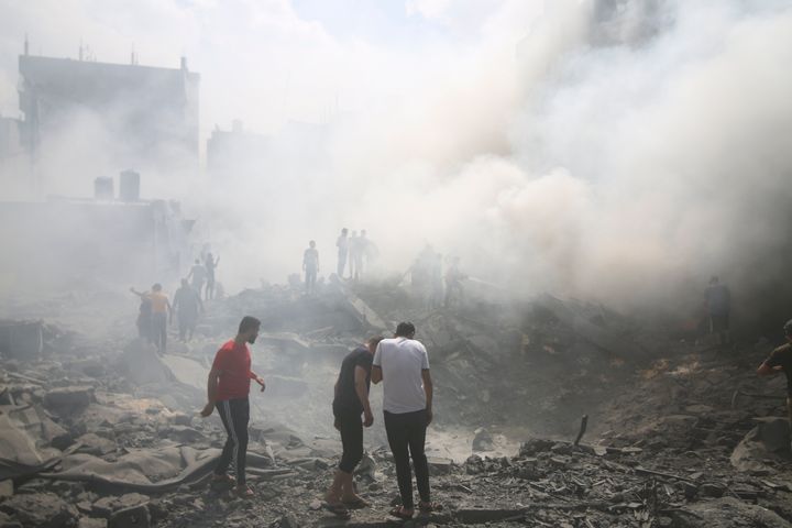Palestinians look for survivors after an Israeli airstrike in Rafah refugee camp, southern Gaza Strip, on Oct. 12, 2023. 