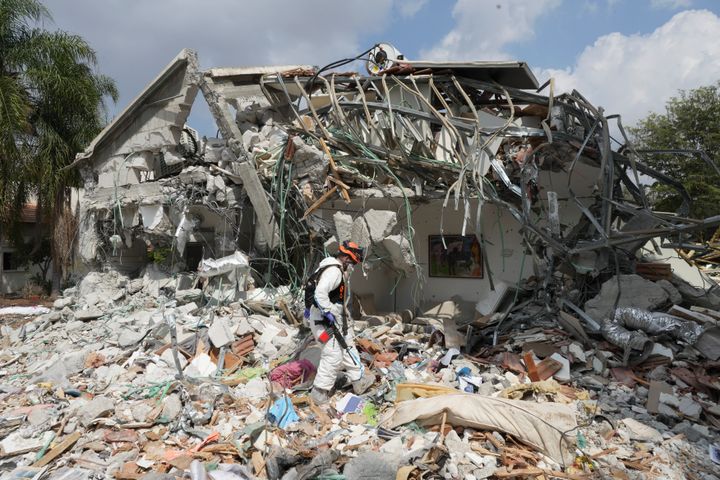 An Israeli soldier walks by a house destroyed by Hamas militants in Kibbutz Be'eri on Oct. 11, 2023.