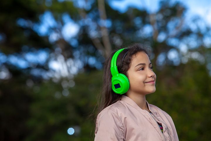Teenager enjoying life with headphones in natural park