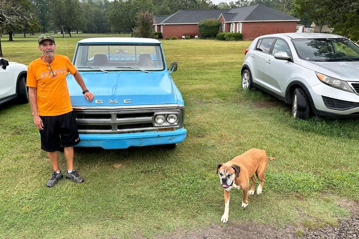 Ricky Dority poses for a photo with his 1969 GMC pickup and his family dog "Boots" outside his family's home in Greenwood, Ark., on Friday, Sept. 22, 2023.