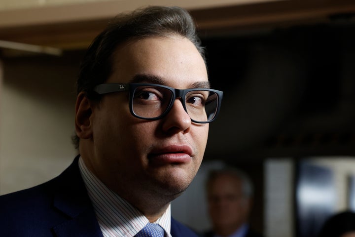 Rep. George Santos (R-N.Y.) leaves a House Republican conference meeting Thursday at the U.S. Capitol.