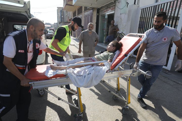 A child injured as a result of Israeli attacks is brought to a hospital in Rafah, Gaza, on Oct. 13.